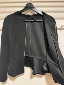Black blazer with front zipper.