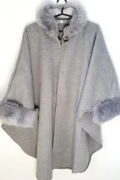 poncho with a faux fur trim on the hood and cuffs.