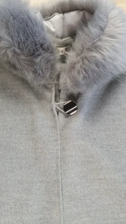 poncho with a faux fur trim on the hood and cuffs.