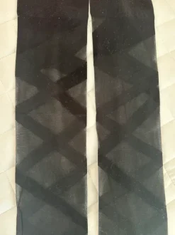 Thin sheer black thigh-high stockings