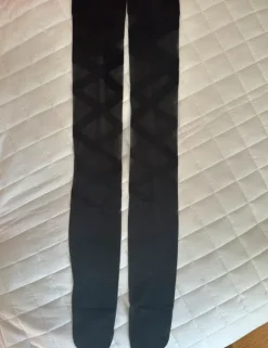 Thin sheer black thigh-high stockings